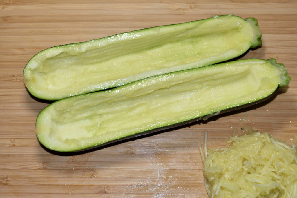 Zucchini richtig füllen - so geht's (3/6) | Jetzt kommt der schwierige Teil: Mit einem Teelöffel, besser aber mit einem Kugelausstecher oder einem Zestenreißer, entfernst Du vorsichtig das Innere.